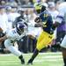 Michigan quarterback Devin Gardner runs the ball for a first down past Northwestern cornerback Demetrius Dugar in the second quarter at Michigan Stadium on Saturday. Melanie Maxwell I AnnArbor.com